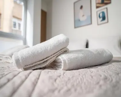 two towels sitting on top of a bed at Tettix Athens Appartment B1 in Athens
