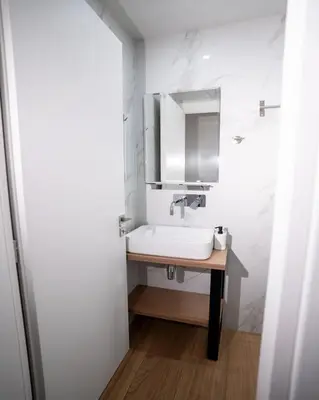 a white bathroom with a sink and a mirror at Tettix Athens Appartment B1 in Athens