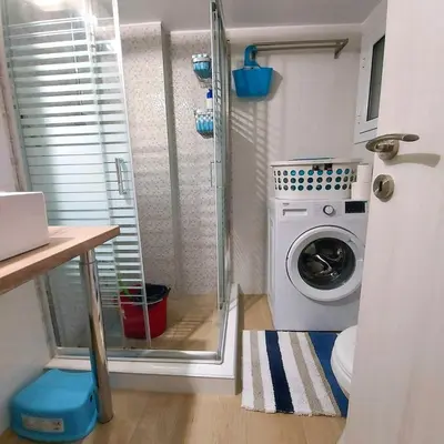 a laundry room with a washing machine in a bathroom at Noeli Apartment by ΜΡS in Athens