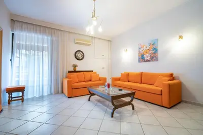 a living room with two orange couches and a table at Authentic Athens stay in Kypseli by ΜΡS in Athens