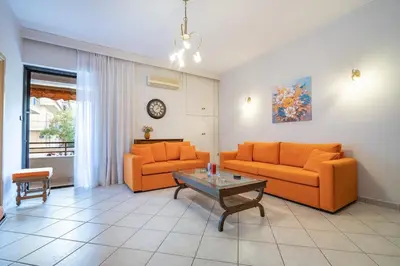 a living room with two orange couches and a table at Authentic Athens stay in Kypseli by ΜΡS in Athens