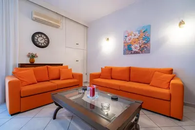 a living room with two orange couches and a table at Authentic Athens stay in Kypseli by ΜΡS in Athens
