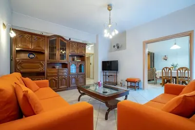 a living room with orange furniture and a table at Authentic Athens stay in Kypseli by ΜΡS in Athens