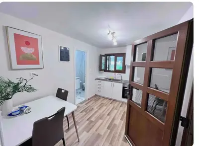 a kitchen with a white table and a dining room at Glyfada center apartment with private yard in Athens