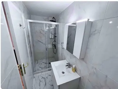 a white bathroom with a sink and a shower at Glyfada center apartment with private yard in Athens