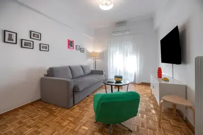 a living room with a couch and a table at Colorful Koukaki Apartment Near the Acropolis in Athens