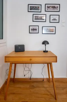 a wooden desk with a lamp on top of it at Colorful Koukaki Apartment Near the Acropolis in Athens
