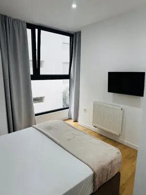 a bedroom with a bed and a large window at Glyfada Unique Luxury & Spacious Apartment in Athens