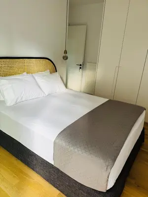 a bedroom with a large bed with white sheets at Glyfada Unique Luxury & Spacious Apartment in Athens