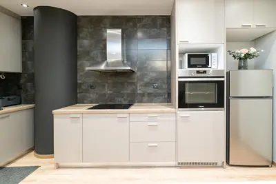 a kitchen with white cabinets and a refrigerator at Athens Dimora Di Aristotele 2 in Athens