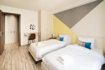 two beds in a hotel room with two beds at Athens Dimora Di Aristotele 2 in Athens