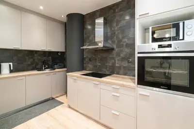 a kitchen with white cabinets and stainless steel appliances at Athens Dimora Di Aristotele 2 in Athens