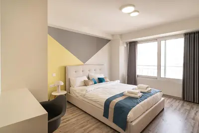 a bedroom with a large bed and a window at Athens Dimora Di Aristotele 3 in Athens