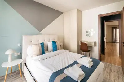 a bedroom with a large bed with towels on it at Athens Dimora Di Aristotele 3 in Athens