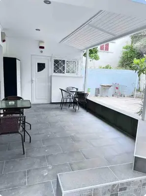 a patio with chairs and tables and a view of the water at A warm home near the center 2 in Athens