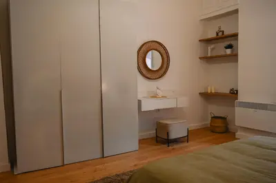 a bedroom with a large white cabinet and a mirror at Portside Residence Piräus in Piraeus