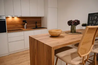 a kitchen with a wooden table with a bowl on it at Portside Residence Piräus in Piraeus