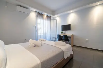 a bedroom with a white bed with towels on it at Kastella Sea Breeze Studio by ΜΡS in Piraeus