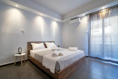 a bedroom with a large bed with towels on it at Kastella Sea Breeze Studio by ΜΡS in Piraeus