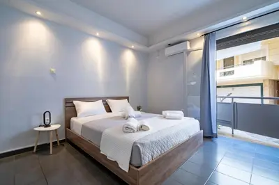 a bedroom with a large bed with towels on it at Kastella Sea Breeze Studio by ΜΡS in Piraeus