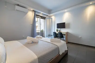a bedroom with a large bed with towels on it at Kastella Sea Breeze Studio by ΜΡS in Piraeus