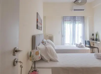 a hotel room with two beds and a room at ANDIE Agios Eleftherios in Athens