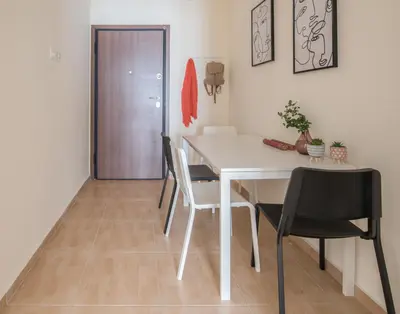a dining room with a white table and chairs at ANDIE Agios Eleftherios in Athens