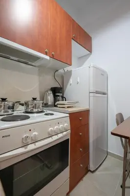 a kitchen with a white stove and a refrigerator at Authentic Athens Living In Zografou by ΜΡS in Athens