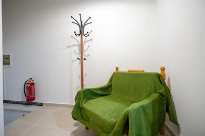a green chair with a green blanket on it at Authentic Athens Living In Zografou by ΜΡS in Athens