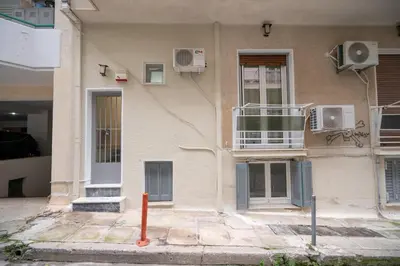 a building with a balcony on the side of it at Authentic Athens Living In Zografou by ΜΡS in Athens
