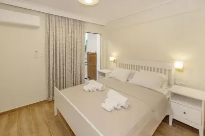 a bedroom with a bed with towels on it at Riviera Garden House in Athens