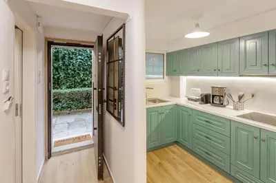 a kitchen with green cabinets and a window at Riviera Garden House in Athens