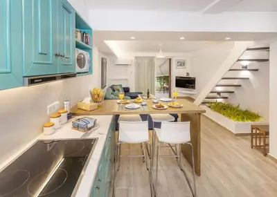 a kitchen with a table and chairs in a room at Riviera Garden House in Athens