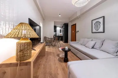 a living room with a couch and a table at Acropolis Boutique Retreat in Koukaki Area Athens in Athens