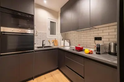 a kitchen with gray cabinets and a counter top at Acropolis Boutique Retreat in Koukaki Area Athens in Athens