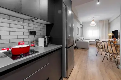 a kitchen with a red pot on top of a stove at Acropolis Boutique Retreat in Koukaki Area Athens in Athens