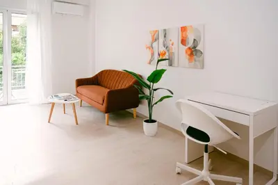 a white room with a desk and a chair and a plant at Spacious 2BR house in Nea Smyrni in Athens