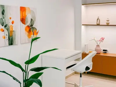 a white desk and a plant in a room at Spacious 2BR house in Nea Smyrni in Athens