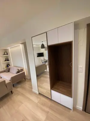 a living room with a large mirror and a bedroom at Sky5 Apartment in Athens