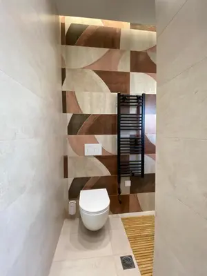 a bathroom with a white toilet in a room at Sky5 Apartment in Athens