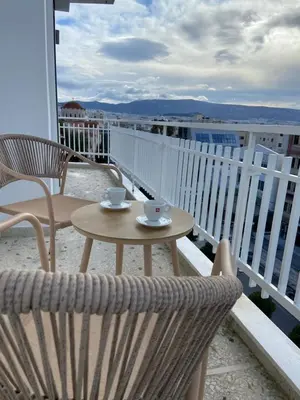 a patio with a table and chairs on a balcony at Sky5 Apartment in Athens
