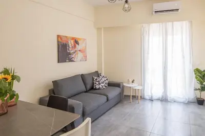a living room with a couch and a table at ANDIE Athens Koukaki in Athens