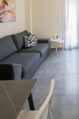 a living room with a couch and a table at ANDIE Athens Koukaki in Athens