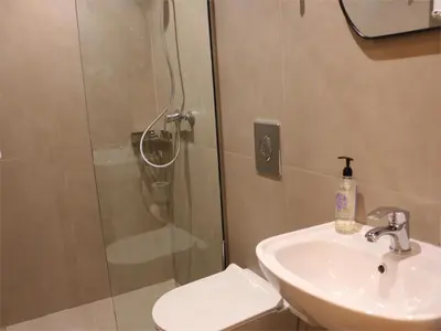 a bathroom with a shower and a sink and a toilet at FaliroRelax F2 in Athens
