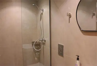 a shower in a bathroom with a mirror at FaliroRelax F2 in Athens