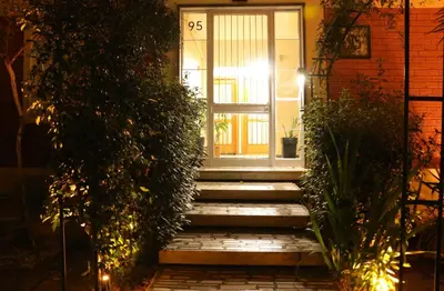 a front door of a house with stairs and plants at FaliroRelax F2 in Athens