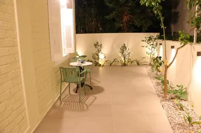 a patio with a table and a chair on a sidewalk at FaliroRelax F2 in Athens
