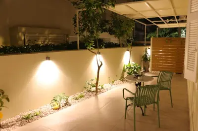 a patio with a table and chairs and plants at FaliroRelax F2 in Athens