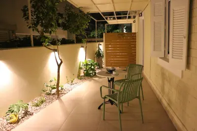 a patio with two chairs and a table and a window at FaliroRelax F2 in Athens