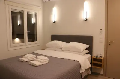 a bedroom with a bed with towels on it at FaliroRelax F2 in Athens